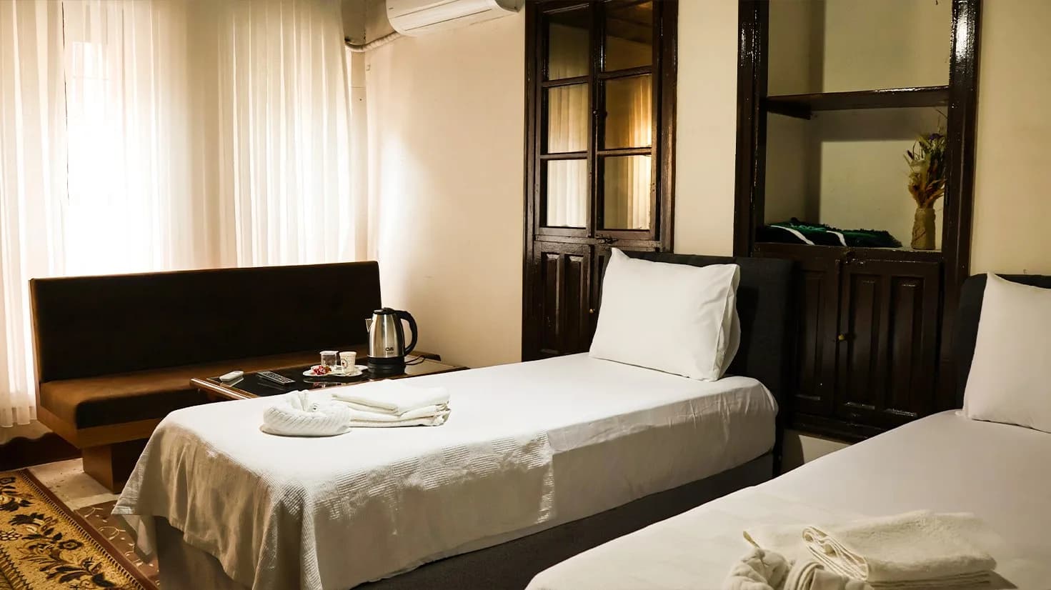 Single beds and wooden cupboards in the Sedir Room